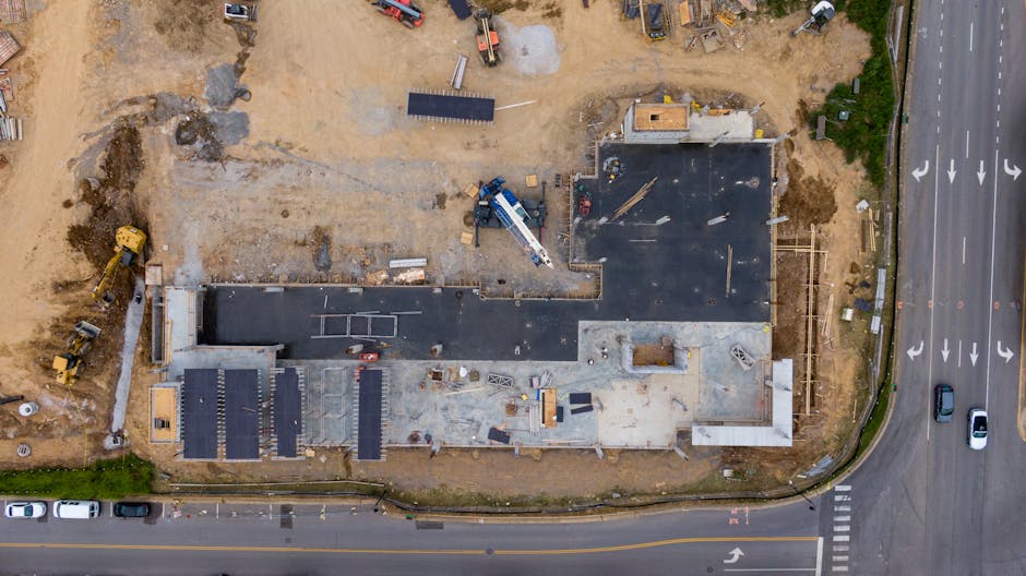 Aerial view of an active construction site with machinery and vehicles