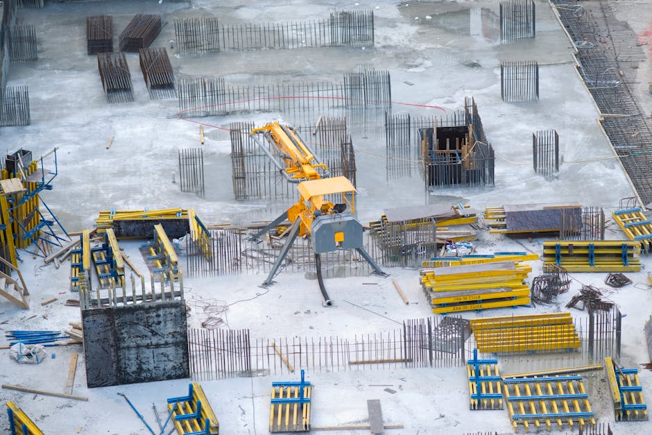 Aerial view of an active construction site with heavy machinery and building materials